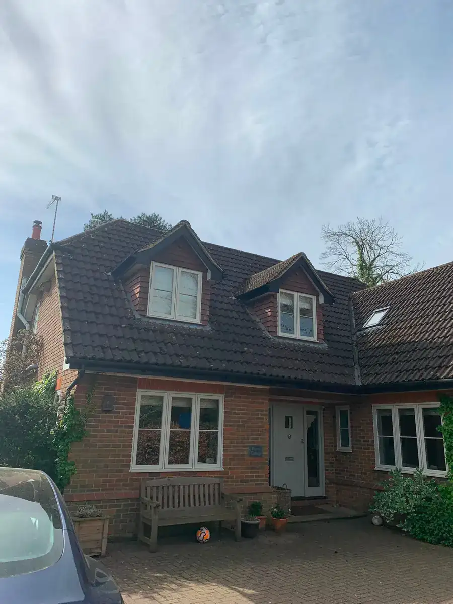 Traditional tiled roof with dormer windows on a detached cottage