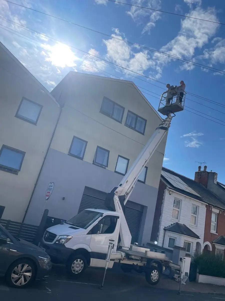 TP Home Improvements team working from a cherry picker on a three storey property