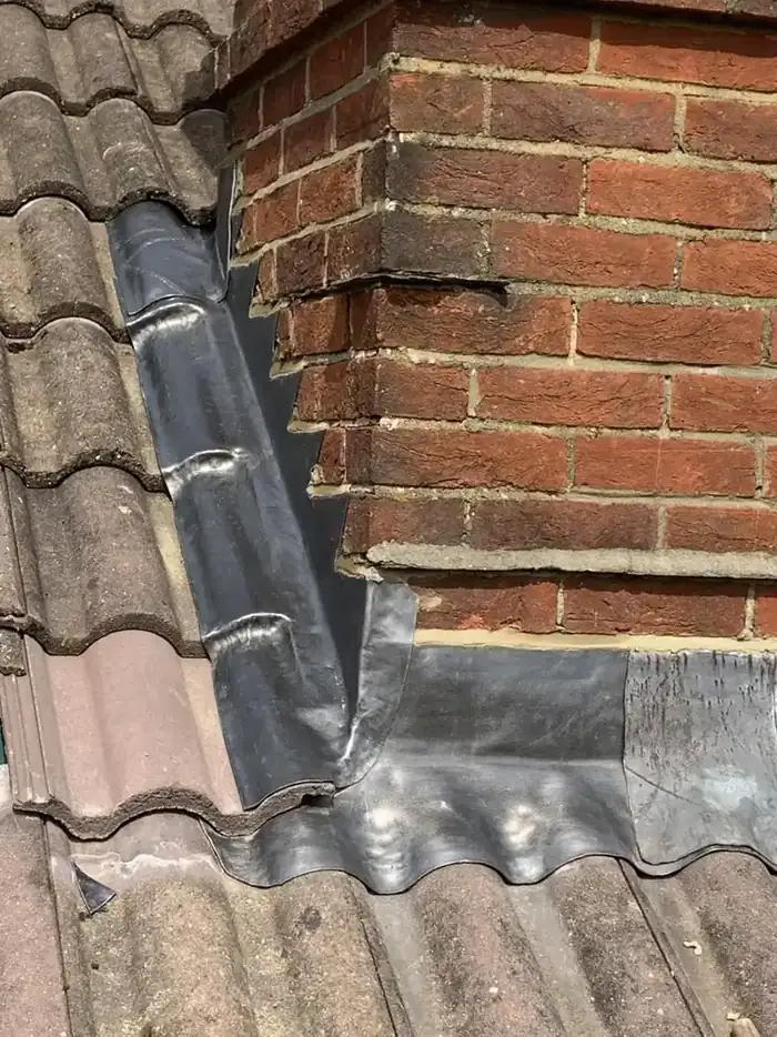 New lead flashing and stepped chimney abutment on a tiled roof